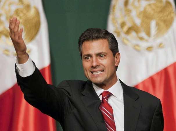 Presidential candidate Enrique Pena Nieto waves to supporters at his party's headquarters in Mexico City, early Monday, July 2, 2012.