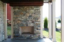 One of two outdoor stone fireplaces