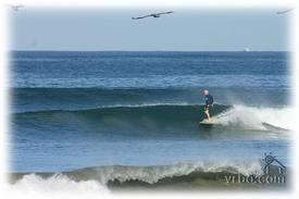 surfer riding wave in tamarindo costa rica