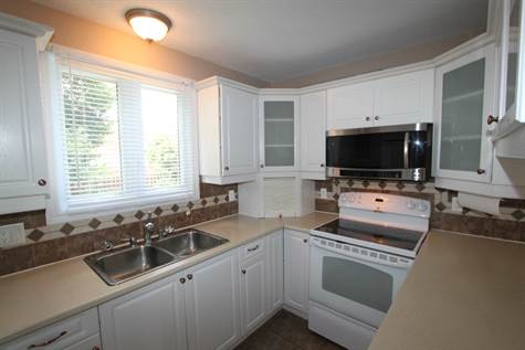Renovated kitchen with glass cupboards.