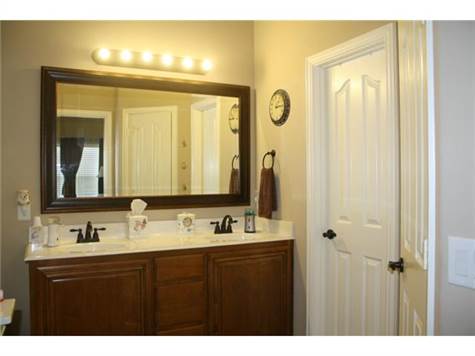 Master bathroom with dual sinks on a raised vanity, oil rubbed b
