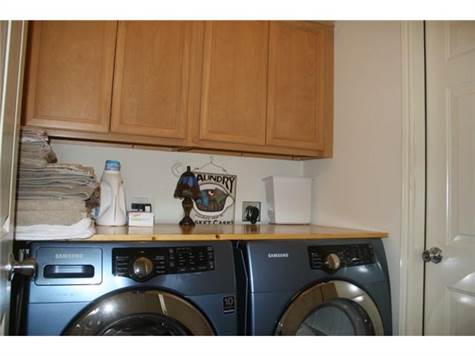 Laundry room with plenty of storage cabinets.