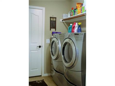 Laundry room, washer and dryer with pedestals will convey with t