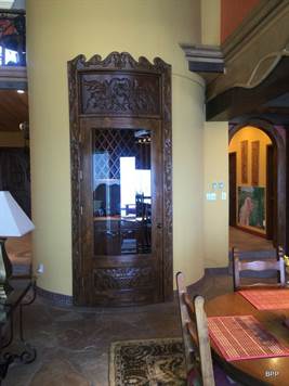 Custom wood carved doorway to wine cellar